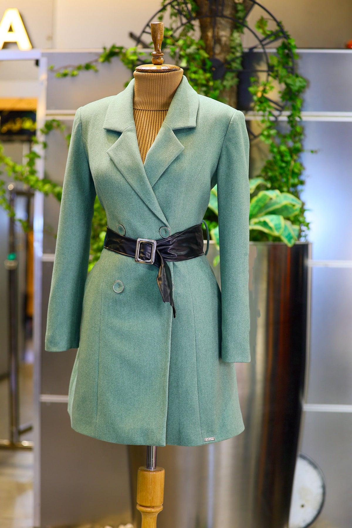 Real photographed green coat on mannequin